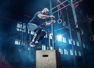 Man jumping during exercises in the fitness gym. CrossFit concept. gym, sport, rope, training, athlete, workout exercises concept