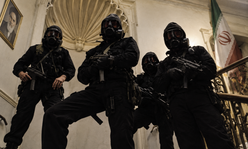 SAS operators in black assault clothing, hoods and respirators gather together after the Iranian Embassy assault in London.