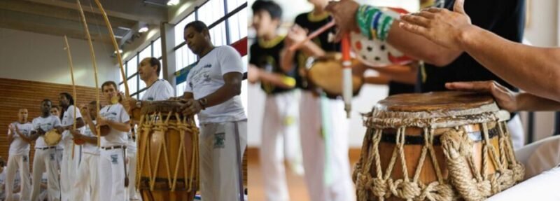 Capoeira musicians playing berimbau and drums while practitioners perform inside a Roda.