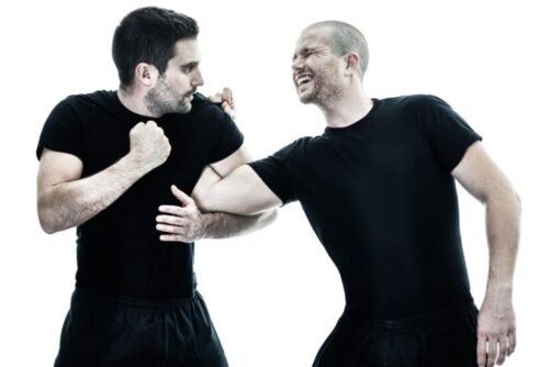 Krav Maga practitioner controlling an attacker’s arm during a close-quarters counter technique in training.