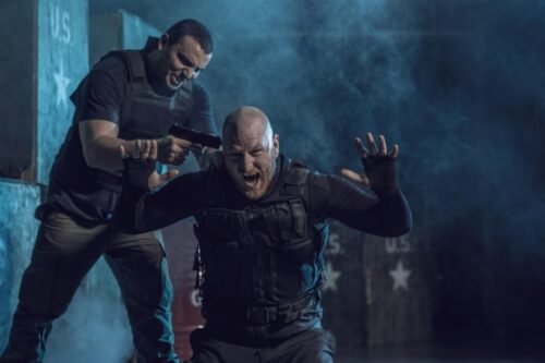 Man in a life-threatening confrontation with a gun held to his head during a high-pressure scenario.