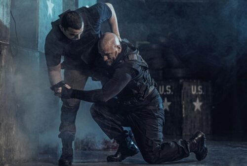 Krav Maga practitioner performing a single-leg takedown during close-quarters self-defence training.