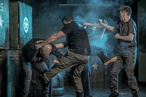 Krav Maga practitioner defending against multiple attackers during a pressure-based training scenario.