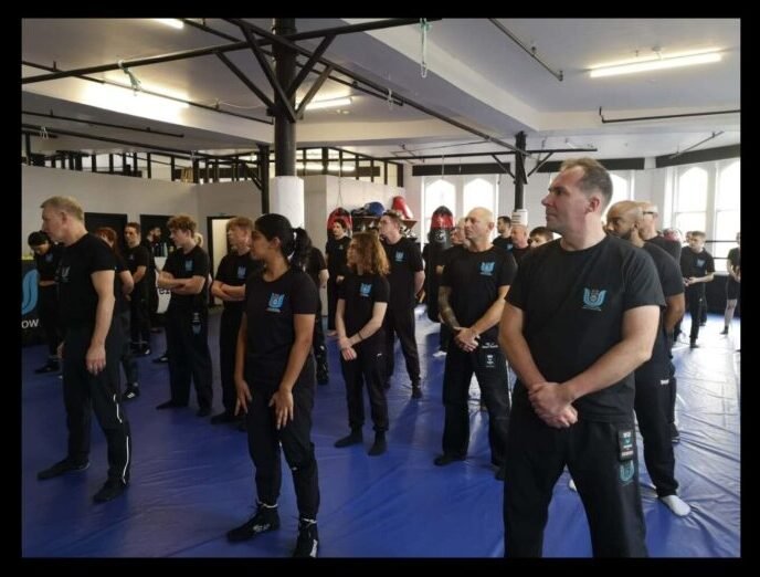 Krav Maga class standing in rank and file formation before beginning structured training drills.