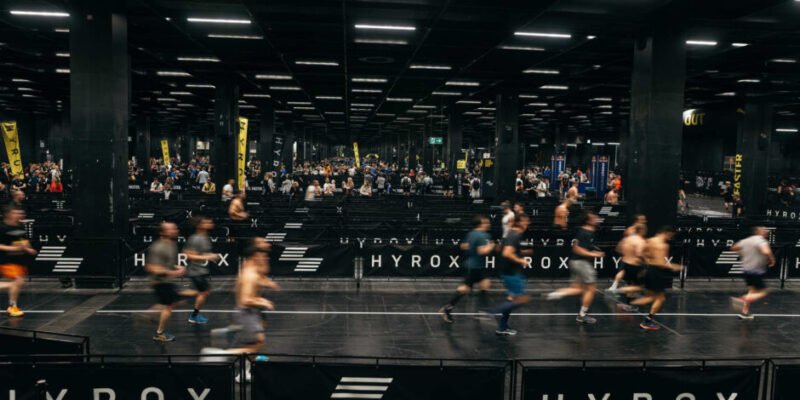 Hyrox athletes running a 1 km stage, marking the start of the challenge after registering for the event.