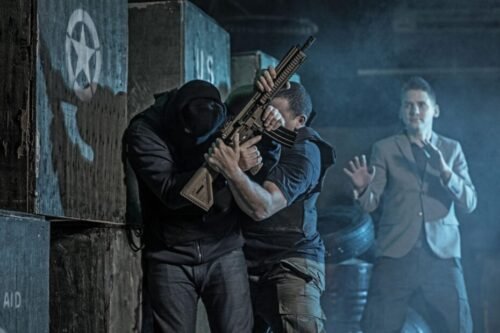 Security or military personnel using Krav Maga techniques to control an armed attacker during a close-quarters engagement.