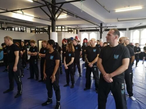 Krav Maga class standing in formation before training begins in a structured group environment.