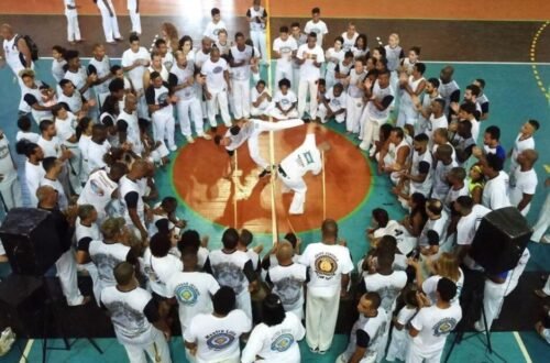 Modern Capoeira practitioners participating in a roda during a cultural gathering.